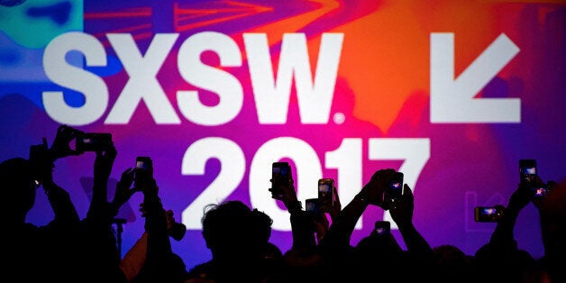 Attendees use hand held phones to take photographs at the 2017 South By Southwest (SXSW) Interactive Festival at the Austin Convention Center in Austin, Texas, U.S., on Sunday, March 12, 2017. The SXSW Interactive Festival features a variety of tracks that allow attendees to explore what's next in the worlds of entertainment, culture, and technology. Photographer: David Paul Morris/Bloomberg via Getty Images