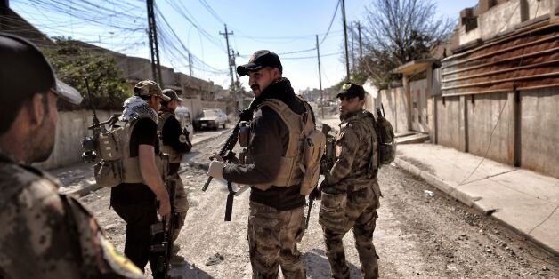 Iraqi troops patrol at retaken areas in west Mosul on March 10, 2017 as they advance in the city in the ongoing battle to seize it from the jihadists of the Islamic State (IS) group. / AFP PHOTO / ARIS MESSINIS (Photo credit should read ARIS MESSINIS/AFP/Getty Images)