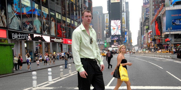 UNITED STATES - AUGUST 05: Neil Fingleton, the tallest man in the world at 7' 7.5' strolls through Times Square and meets tourists and New Yorkers who are asking for his autograph. (Photo by David Handschuh/NY Daily News Archive via Getty Images)