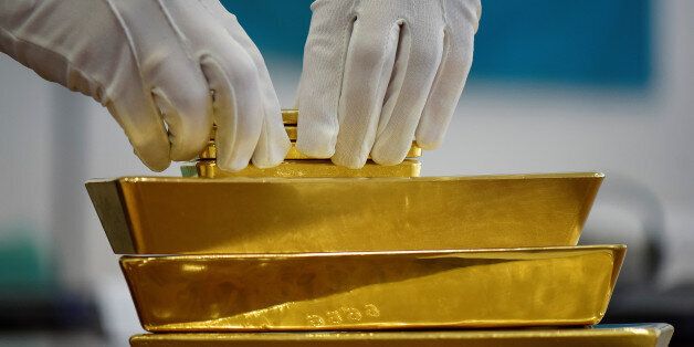 An employee places gold bars in the Kazakhstan's National Bank vault in Almaty, Kazakhstan, September 30, 2016. REUTERS/Mariya Gordeyeva