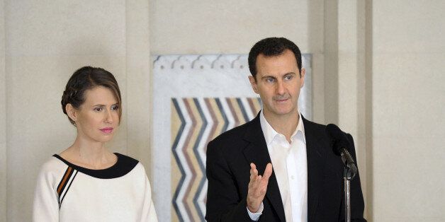 Syria's President Bashar al-Assad stands next to his wife Asma, as he addresses injured soldiers and their mothers during a celebration marking Syrian Mother's Day in Damascus, in this handout picture provided by SANA on March 21, 2016. SANA/Handout via REUTERS ATTENTION EDITORS - THIS IMAGE WAS PROVIDED BY A THIRD PARTY. EDITORIAL USE ONLY. REUTERS IS UNABLE TO INDEPENDENTLY VERIFY THIS IMAGE SEARCH
