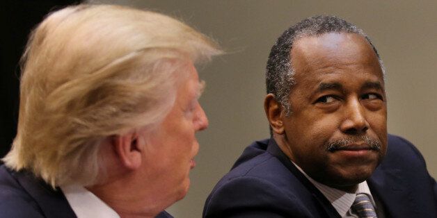 U.S. President Donald Trump attends an African American History Month listening session, accompanied by the Housing and Urban Development Secretary Ben Carson (R) at the Roosevelt room of the White House in Washington U.S., February 1, 2017. REUTERS/Carlos Barria