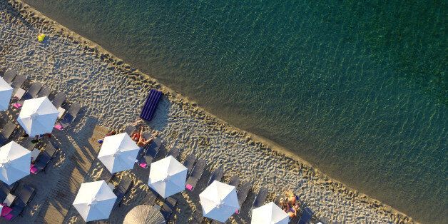 HALKIDIKI, GREECE - JUNE 23: Aerial view of The Pefkochori beach with umbrellas on June 23, 2015 in Halkidiki, Greece. Pefkochori is a tourist town located in the southeast of the peninsula of Kassandra and named after the pine trees which are abundant in the mountains of the area. (Photo by Athanasios Gioumpasis/Getty Images)