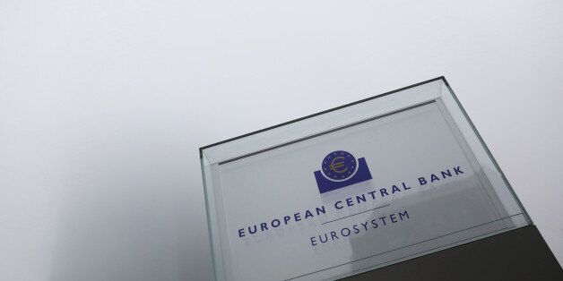 A euro currency symbol sits on a sign as the European Central Bank (ECB) skyscraper headquarter offices stand shrouded in fog beyond, ahead of a news conference to announce the bank's interest rate decision in Frankfurt, Germany, on Thursday, Dec. 8, 2016. European stocks extended their gains into a fourth day ahead of the ECB's meeting today, with all eyes on Draghi for cues on further stimulus. Photographer: Alex Kraus/Bloomberg via Getty Images