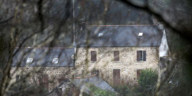 A picture taken on March 7, 2017 in Pont-de-Buis, western France shows a view of the house of Lydie Troadec, sister of Pascal Troadec who went missing with his wife and two children, and his partner Hubert Caouissin, suspected of the killing of all four members of the family on February 16, as police look for the bodies. The father's brother-in-law Hubert Caouissin, who has confessed to the gruesome killing motivated by an inheritance dispute over gold coins,, went on to cut up the bodies, burning some parts and burying others, the prosecutor of the western city of Nantes said on March 6. He is to be charged with murder, while his partner Lydie -- Pascal's sister -- faces charges of tampering with evidence and abetting the crime by helping him dispose of the bodies, the prosecutor said. / AFP PHOTO / FRED TANNEAU (Photo credit should read FRED TANNEAU/AFP/Getty Images)
