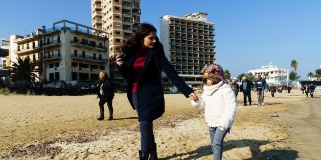 Greek Orthodox Cypriots attend the traditional 'Blessing of the Sea' ceremony in celebration for Epiphany on January 6, 2017, outside the fenced-off touristic area of Varosha in the eastern port city of Famagusta in the self-proclaimed Turkish Republic of Northern Cyprus (TRNC).This is the second time in 43 years that the Epiphany has been celebrated in the Turkish-occupied side of the divided eastern Mediterranean island. / AFP / Iakovos Hatzistavrou (Photo credit should read IAKOVOS HAT