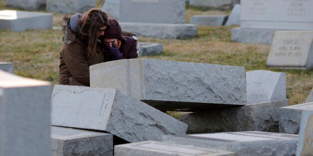 Melanie Steinhardt comforts Becca Richman at the Jewish Mount Carmel Cemetery, February 26, 2017, in Philadelphia, PA.Police say more than 100 tombstones were vandalized a week after a Jewish cemetery in St. Louis was desecrated. / AFP / DOMINICK REUTER (Photo credit should read DOMINICK REUTER/AFP/Getty Images)