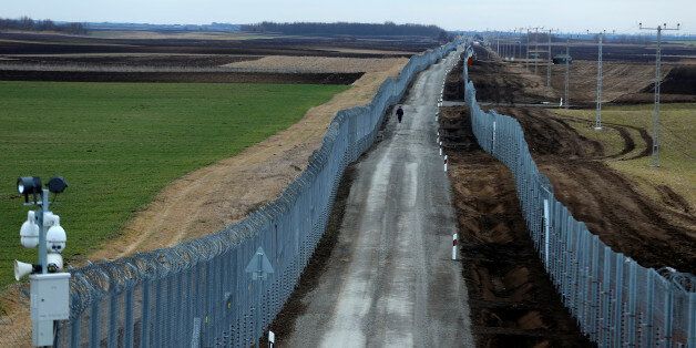 A Hungarian policeman patrols the Hungary-Serbia border, which was recently fortified by a second fence, near the village of Gara, Hungary March 2, 2017.REUTERS/Laszlo Balogh