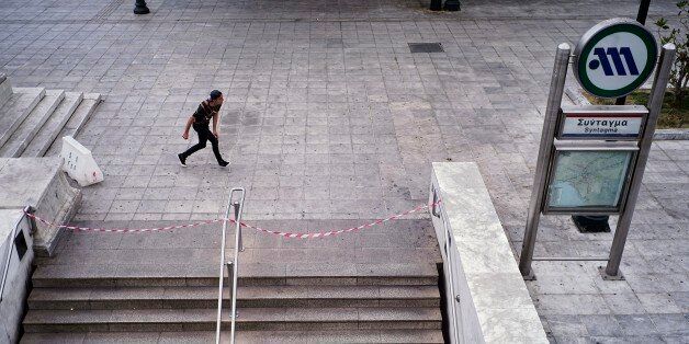 ATHENS, GREECE - MAY 6: A young man practice break dancing in front of a notice that announces the closure of the central metro station Sintagma during a 48-hour nationwide general strike on May 6 in Athens, 2016. Unions called the strike to protest against pension reforms that are part of Greece's third international bailout. (Photo by Milos Bicanski/Getty Images)