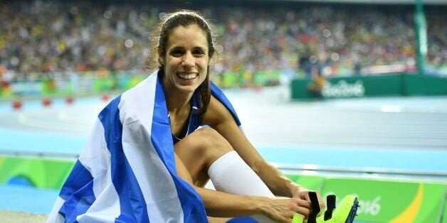 Greece's Aikaterini Stefanidi celebrates after she won the Women's Pole Vault Final during the athletics event at the Rio 2016 Olympic Games at the Olympic Stadium in Rio de Janeiro on August 19, 2016. / AFP / Leon NEAL (Photo credit should read LEON NEAL/AFP/Getty Images)