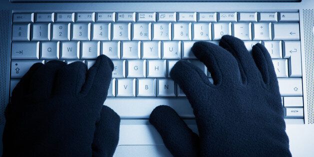 IT Crime consept Hacker works on laptop