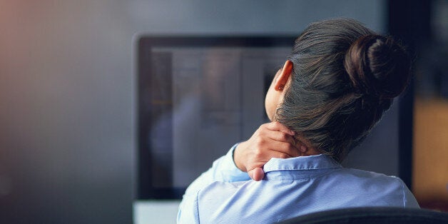 Rearview shot of a businesswoman suffering from neck pain at the officehttp://195.154.178.81/DATA/i_collage/pi/shoots/806127.jpg