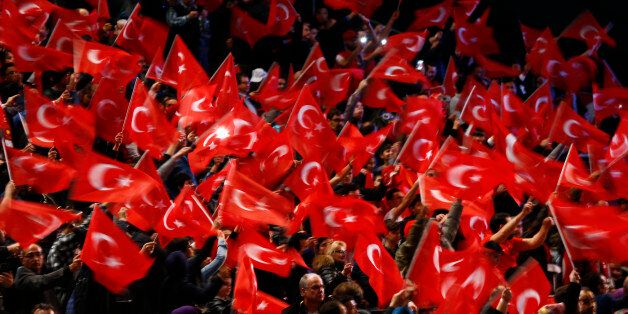 People wave with flags before Turkish Prime Minister Binali Yildirim is expected to address a crowd of around 10,000 in Oberhausen, Germany, February 18, 2017, to promote Turkey's constitution referendum on April 16, 2017. REUTERS/Wolfgang Rattay