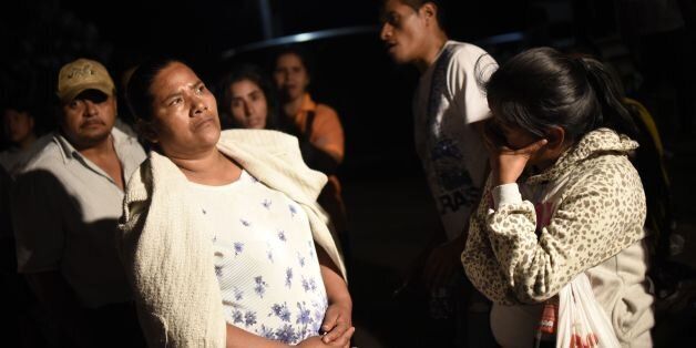 Relatives wait for information outside the children's shelter Virgen de la Asuncion after a fire at the facility killed at least 20 people, in San Jose Pinula, about 10 kilometres east of Guatemala City, on March 8, 2017. At least 20 teenage girls died in a fire at a children's shelter in Guatemala, a spokesman for the local fire service said. It was not immediately known how many of the bodies were those of children. The center, supervised by state social welfare authorities, hosts minors who are victims of family mistreatment. The facility has been the target of multiple complaints alleging abuse, and several children have run away. / AFP PHOTO / JOHAN ORDONEZ (Photo credit should read JOHAN ORDONEZ/AFP/Getty Images)
