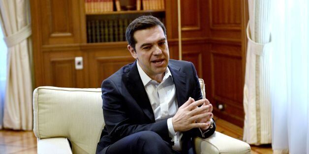 Greek Prime Minister Alexis Tsipras talks to top EU economic affairs official during their meeting in Athens on February 15, 2017. Pierre Moscovici meets with Greek leaders in Athens in a bid to break the deadlock between the debt-laden country and its creditors.The visit by the former French finance minister comes after months of failed talks between Athens and its eurozone and International Monetary Fund (IMF) lenders. / AFP / LOUISA GOULIAMAKI (Photo credit should read LOUISA GOULIAMAKI/AFP/Getty Images)
