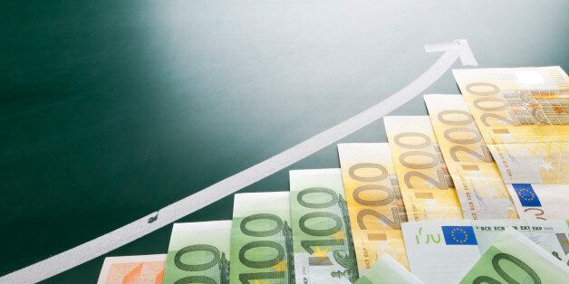 Euro banknotes and growing arrow on blackboard
