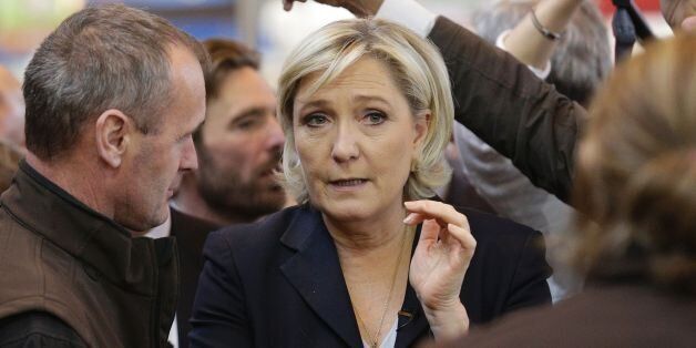 French far-right Front National (FN) party candidate for the presidential election Marine Le Pen (C) speaks with a farmer during a visit at the Agriculture Fair in Paris on February 27, 2017. / AFP / GEOFFROY VAN DER HASSELT (Photo credit should read GEOFFROY VAN DER HASSELT/AFP/Getty Images)