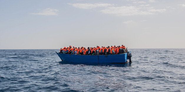 AT SEA, AT SEA - FEBRUARY 18: Migrants and refugees are assisted by members of the Spanish NGO Proactiva Open Arms as they crowd on board of a wooden boat sailing out of control at 20 miles (38 km) north of Sabratha, Libya on February 18, 2017 at Sea. 466 migrants have been rescued in high seas since yesterday evening by the Italian Coast Guard and the Spanish NGO Proactiva Open Arms rescue vessel Golfo Azzurro as they continue to search for more boats. Proactiva Open Arms are a Spanish charity based out of Malta who provide search and rescue assistance to refugees and migrants in distress at sea. They patrol the SAR and Rescue Zone off the coast of Libya running rescue missions for the hundreds of migrants who continue to make the perilous journey across the Mediterranean in the hope of reaching the European mainland. (Photo by David Ramos/Getty Images)