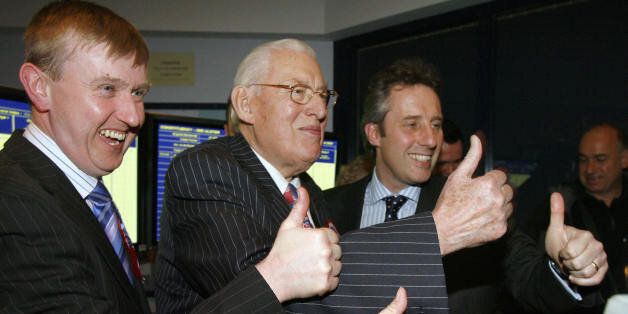 BELFAST, United Kingdom: Ian Paisley (C), leader of the Democratic Unionist Party (DUP), gives the thumbs up sign with his son Ian Paisley Jr. (R) and DUP member Mervin Story (L) after winning the election in Ballymena, Northern Ireland, 08March 2007. Paisley, the leader of Northern Ireland's largest Protestant party, was re-elected in the elections that could see a power-sharing government set up in the British-run province. The 80-year-old Paisley, the Democratic Unionist Party's candidate as first minister, topped the poll in the Antrim North constituency with 7,716 votes. AFP PHOTO/Peter MUHLY (Photo credit should read PETER MUHLY/AFP/Getty Images)