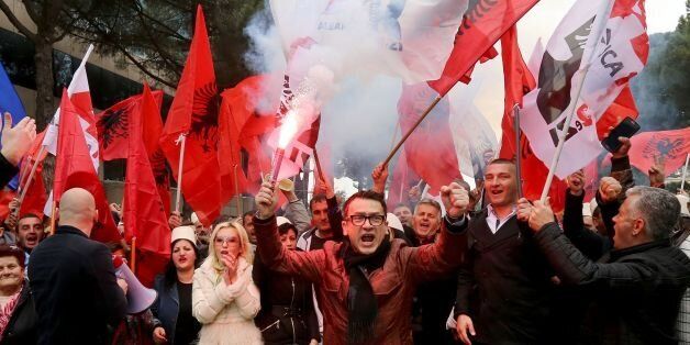 Supporters of the Albanian opposition shout anti-Government slogans as they protest in front of the government building in Tirana on February 18, 2017.The opposition requests the resignation of the government and free elections.Gent. / AFP / GENT SHKULLAKU (Photo credit should read GENT SHKULLAKU/AFP/Getty Images)