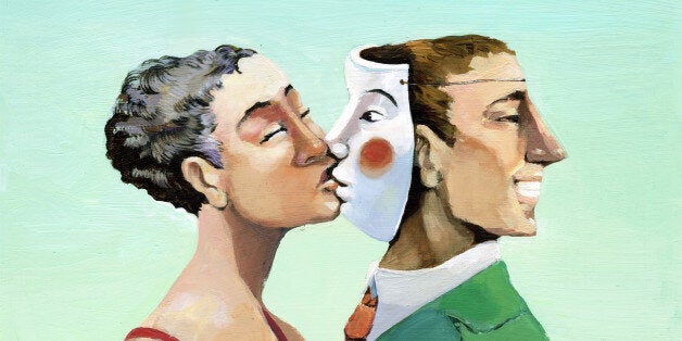 a woman kissing a mask instead of the man who has turned