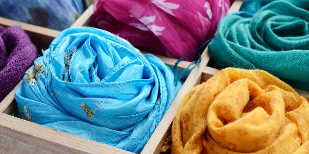 Vintage wooden box with different colorful scarves