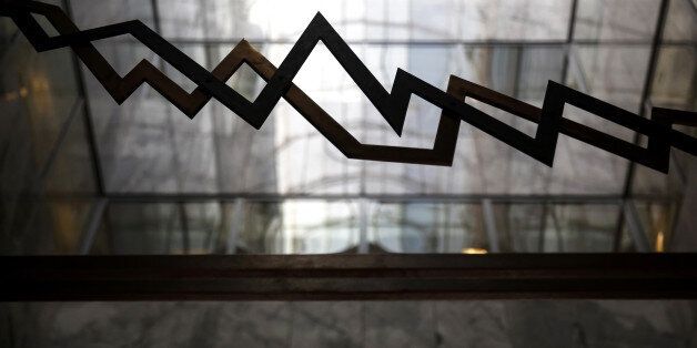 An index curve design sits on a glass panel in the reception area of the Hellenic Exchanges - Athens Stock Exchange SA in Athens, Greece, on Wednesday, Feb. 1, 2017. Greek assets have been roiled since Thursday after a meeting between Finance Minister Euclid Tsakalotos and the nations bailout auditors ended in disagreement last week. Photographer: Yorgos Karahalis/Bloomberg via Getty Images
