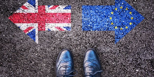 Brexit, flags of the United Kingdom and the European Union on asphalt road with legs