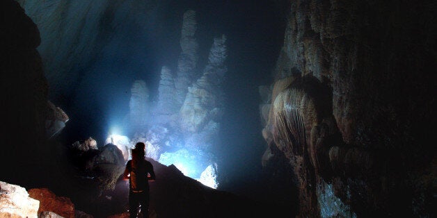 VIETNAM - UNDATED: ***EXCLUSIVE*** The British caving team inside the Hang Son Doong cave in Ke Bang Massif, Vietnam, April 2009. A British Caving team believe they have discovered the largest sized cave passage in the world. Measuring 200 metres in height and 150 metres in width the new cave, called Hang Son Doong (Mountain River Cave), is 6.5 km long. Assisted by representatives of Hanoi University of Science the team explored the new cave for five days. The team spent six hours trekking through the jungle to reach the cave. Climbing down into a large chamber, they had to negotiate two underground rivers before reaching the main passage of the Hang Son Doong. The team will return to Vietnam later in the year to complete the expedition of the cave and conduct a full survey. (Photo by Joint British-Vietnamese Caving Expedition 2009 / Barcroft Media / Getty Images)