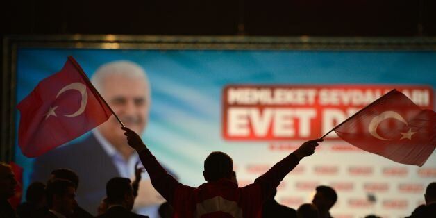 A participant waves Turkish flags during an event with the Turkish Prime Minister in Oberhausen, western Germany, on February 18, 2017. Turkish Prime Minister Binali Yildirim speaks to an expected crowd of some 10,000 people of Turkish origin in Germany to promote support for an April 16, 2017 constitutional referendum on expanding President Recep Tayyip Erdogan's powers. / AFP / Sascha Schuermann (Photo credit should read SASCHA SCHUERMANN/AFP/Getty Images)