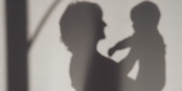 A shadow of a woman holding a baby