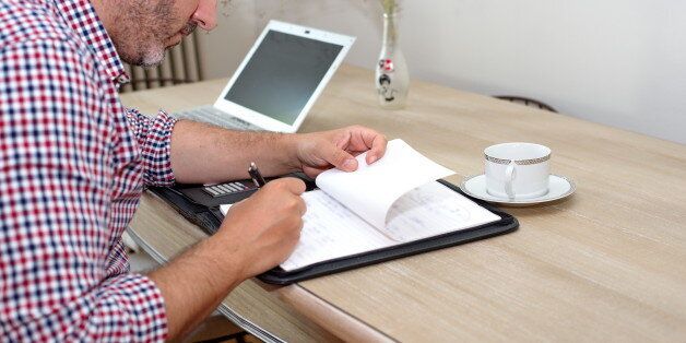 Man on wooden table working at home