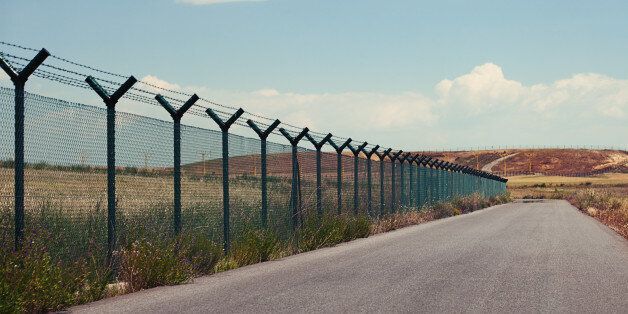Road next to a fence in a clear day.
