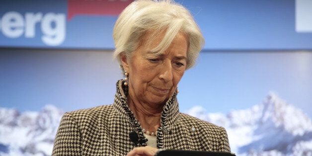 Christine Lagarde, managing director of the International Monetary Fund (IMF), uses a tablet device ahead of a panel session at the World Economic Forum (WEF) in Davos, Switzerland, on Wednesday, Jan. 18, 2017. World leaders, influential executives, bankers and policy makers attend the 47th annual meeting of the World Economic Forum in Davos from Jan. 17 - 20. Photographer: Jason Alden/Bloomberg via Getty Images