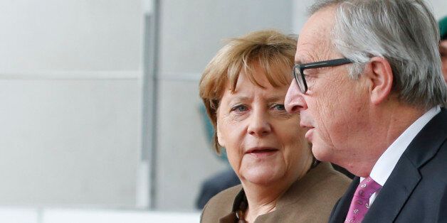 German Chancellor Angela Merkel (L) and European Commission President Jean-Claude Juncker leave the Chancellery...