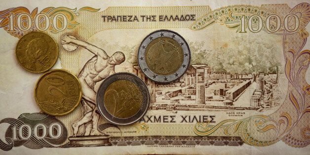 ATHENS, GREECE - JULY 08: In this photo illustration Euro coins lay on a 1000 Drachma note, the currency in Greece before the Euro, on July 8, 2015 in Athens, Greece. Eurozone leaders have offered the Greek government one more chance to propose a viable solution of it's debt or face the possibilty a likely exit from the euro. (Photo by Christopher Furlong/Getty Images)