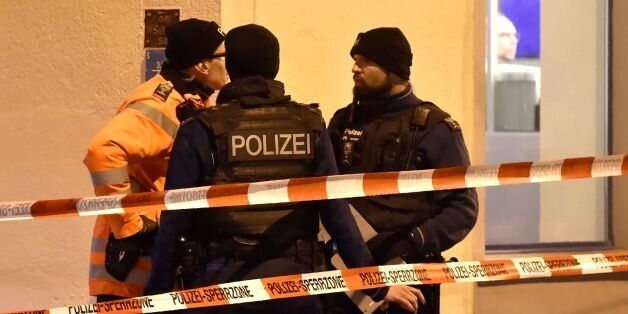 Swiss police stand behind a police cordon outside a Muslim prayer hall at the Eis-Gasse street, central Zurich, on December 19, 2016, after three people were injured by gunfire.Local media reported the incident occurred in the Muslim prayer hall near the city's railway station. Swiss media said the three wounded people, all adults, were found in the street where the prayer hall is located. The suspected assailant had fled the scene and police sealed off the area. / AFP / MICHAEL BUHOLZER (Photo credit should read MICHAEL BUHOLZER/AFP/Getty Images)