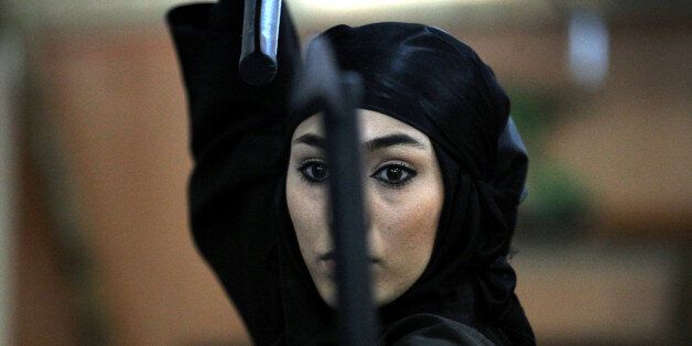 An Iranian female Ninja demonstrates her Ninjutsu skills in a martial arts club during a showcase for the media in the city of Karaj, 40 kms west of the capital Tehran, on March 15, 2012. Martial arts has become popular among Iranian women in recent years as more than 3,000 women train in Ninjutsu in private clubs under the supervision of the Islamic republic's Martial Arts Federation. AFP PHOTO/ATTA KENARE (Photo credit should read ATTA KENARE/AFP/Getty Images)