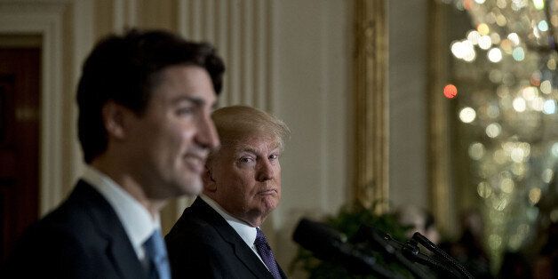 U.S. President Donald Trump listens as Justin Trudeau, Canada's prime minister, left, speaks during a news conference in the East Room of the White House in Washington, D.C., U.S., on Monday, Feb. 13, 2017. Amid talk in the U.S. of resetting trade relationships, Trump and Trudeau said both countries are committed to maintaining trade ties and economic integration that support millions of jobs on both sides of the border. Photographer: Andrew Harrer/Bloomberg via Getty Images