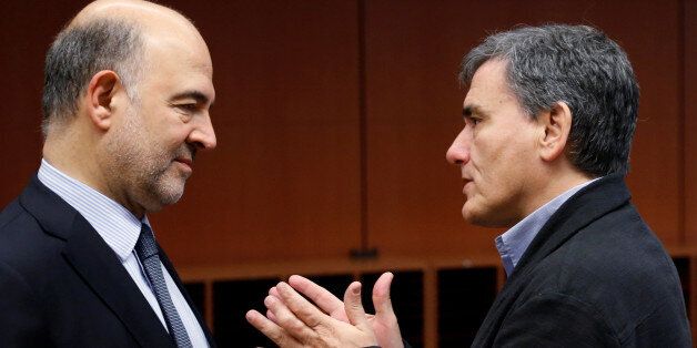European Economic and Financial Affairs Commissioner Pierre Moscovici listens to Greek Finance Minister Euclid Tsakalotos (R) during a euro zone finance ministers meeting in Brussels, Belgium December 5, 2016. REUTERS/Francois Lenoir