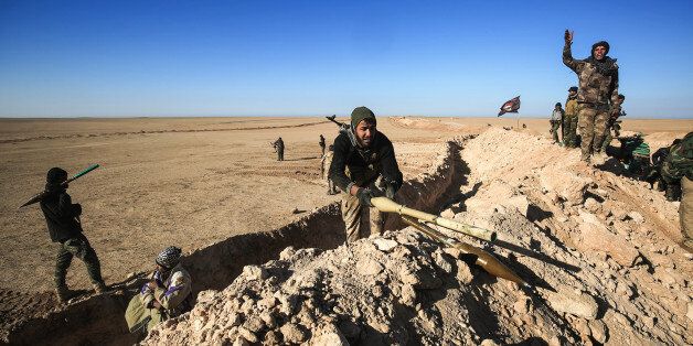 Fighters of the Hashed al-Shaabi (Popular Mobilisation) paramilitaries prepare defensive positions near the frontline village of Ayn al-Hisan, on the outskirts of Tal Afar west of Mosul, where Iraqi forces are preparing for the offensive retake the western side of Mosul from Islamic State (IS) group fighters, on February 18, 2017. / AFP / AHMAD AL-RUBAYE (Photo credit should read AHMAD AL-RUBAYE/AFP/Getty Images)