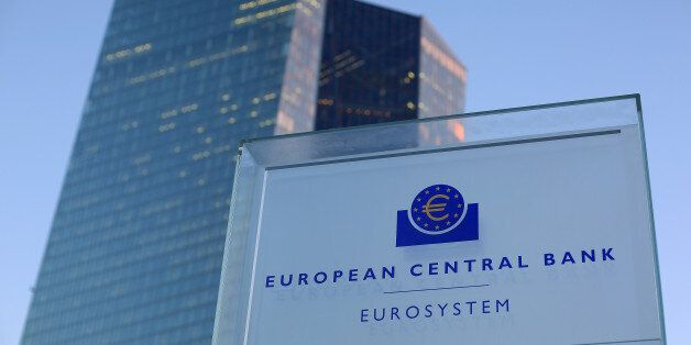 A euro currency symbol sits on a Eurosystem sign outside the European Central Bank (ECB) headquarters in Frankfurt, Germany, on Thursday, Jan. 19, 2017. The ECB left its quantitative-easing program unchanged as policy makers wait to see if a pickup in inflation will be sustained. Photographer: Krisztian Bocsi/Bloomberg via Getty Images