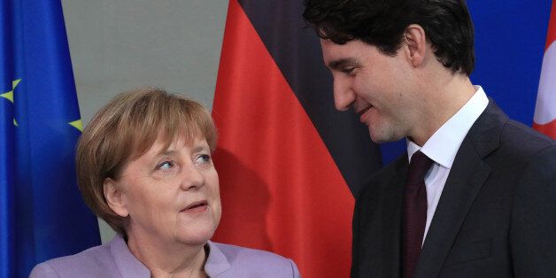 Angela Merkel, Germany's chancellor, left, and Justin Trudeau, Canada's prime minister, stand for a photograph during a news conference at the Chancellery in Berlin, Germany, on Friday, Feb. 17, 2017. Military spending is not the only measure of a countrys contribution to the North Atlantic Treaty Organization, Trudeau said. Photographer: Krisztian Bocsi/Bloomberg via Getty Images