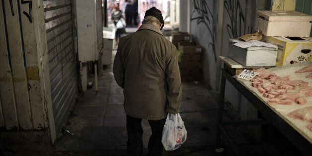 A customer carries his purchases in a plastic bag at Kapani market in Thessaloniki, Greece, on Thursday, Dec. 1, 2016. Greek markets have rallied this month on expectations creditors may finally ease the countrys debt at a Dec. 5 meeting of euro-area finance ministers. Photographer: Konstantinos Tsakalidis/Bloomberg via Getty Images