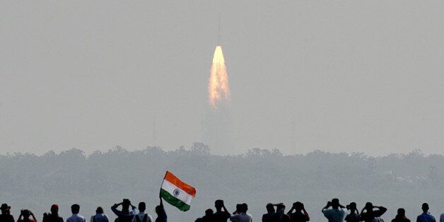 Indian onlookers watch the launch of the Indian Space Research Organisation (ISRO) Polar Satellite Launch Vehicle (PSLV-C37) at Sriharikota on Febuary 15, 2017.India successfully put a record 104 satellites from a single rocket into orbit on February 15 in the latest triumph for its famously frugal space agency. Scientists who were at the launch in the southern spaceport of Sriharikota burst into applause as the head of India's Space Research Organisation (ISRO) announced all the satellites had been ejected. / AFP / ARUN SANKAR (Photo credit should read ARUN SANKAR/AFP/Getty Images)
