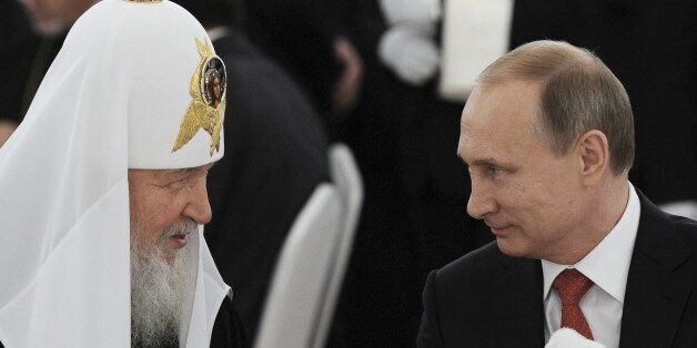 Russian President Vladimir Putin (R) listens to Patriarch of Moscow and all Russia Kirill during a reception commemorating the 1,000th anniversary of the death of Grand prince Vladimir I (Vladimir the Great) at the Kremlin in Moscow, Russia, July 28, 2015. REUTERS/RIA Novosti/Mikhail Klimentyev/Kremlin ATTENTION EDITORS - THIS IMAGE HAS BEEN SUPPLIED BY A THIRD PARTY. IT IS DISTRIBUTED, EXACTLY AS RECEIVED BY REUTERS, AS A SERVICE TO CLIENTS
