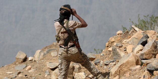A soldier loyal to Yemen's government uses binoculars near Al Khurais village of Nihm district east of the capital Sanaa January 11, 2016. REUTERS/Ali Owidha