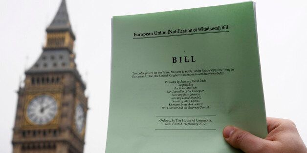A journalist poses with a copy of the Brexit Article 50 bill, introduced by the government to seek parliamentary approval to start the process of leaving the European Union, in front of the Houses of Parliament in London, Britain, January 26, 2017. REUTERS/Toby Melville