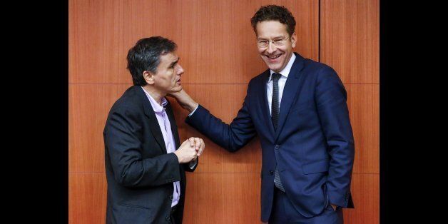 Greek Finance Minister Euclid Tsakalotos (L) chats with Dutch Finance Minister and Eurogroup President Jeroen Dijsselbloem (R) during a eurozone finance ministers meeting in Brussels, Belgium, December 7, 2015. REUTERS/Yves Herman
