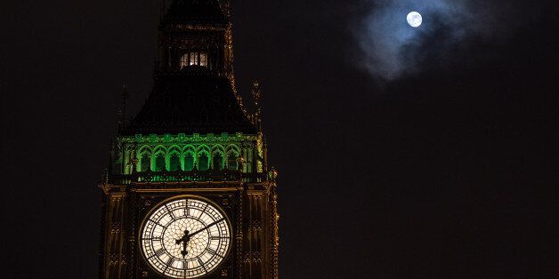 LONDON, ENGLAND - FEBRUARY 08: The moon shines through a brief break in the clouds behind Elizabeth Tower, commonly known as Big Ben, as the Ayrton light is on above the belfry signalling that either Houses of Parliament is sitting after dark on February 8, 2017 in London, England. MPs are debating the European Union (notification of withdrawal) bill that will trigger article 50. They will vote on amendments, including whether to let EU nationals stay in the UK, before a final vote at 20:00 GMT. (Photo by Chris J Ratcliffe/Getty Images)